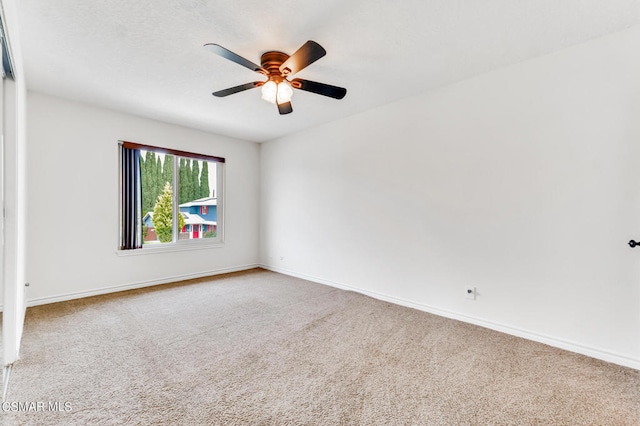 empty room featuring light carpet and ceiling fan