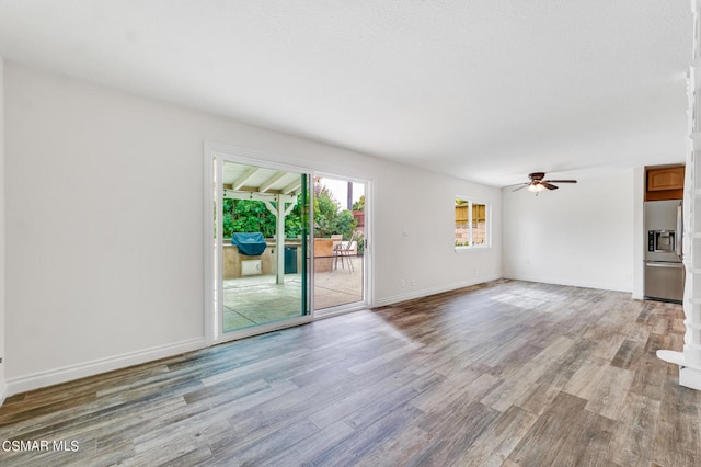 unfurnished living room featuring ceiling fan and light hardwood / wood-style flooring