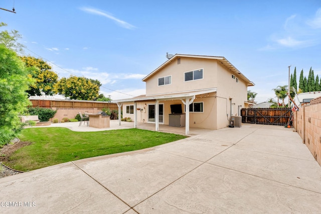 back of house with a patio, a yard, and central AC unit