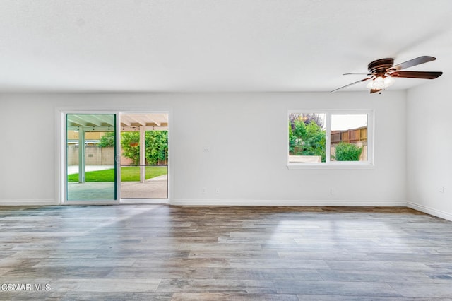 empty room with ceiling fan and light wood-type flooring