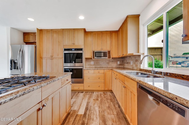 kitchen featuring light hardwood / wood-style flooring, stainless steel appliances, sink, and light brown cabinets