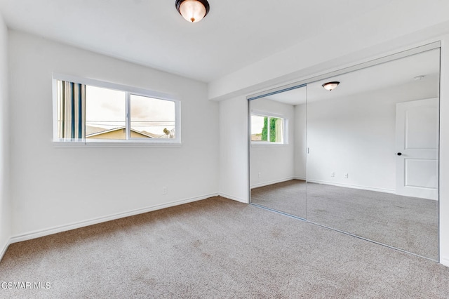 unfurnished bedroom with carpet and a closet