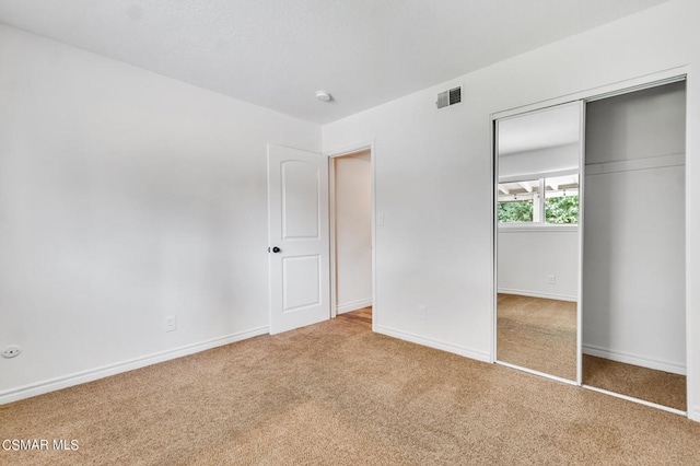 unfurnished bedroom featuring a closet and carpet floors