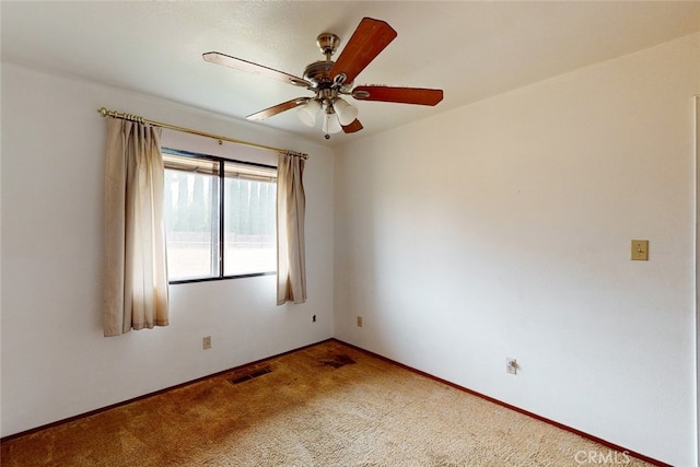 carpeted spare room featuring ceiling fan