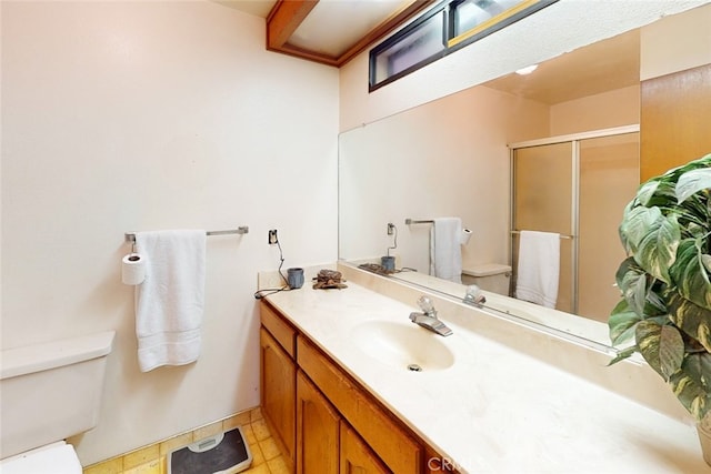 bathroom with vanity, toilet, a shower with shower door, and tile patterned flooring