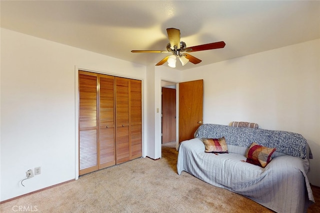 carpeted bedroom featuring a closet and ceiling fan