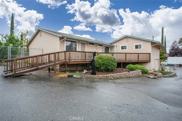 view of front of home featuring a wooden deck