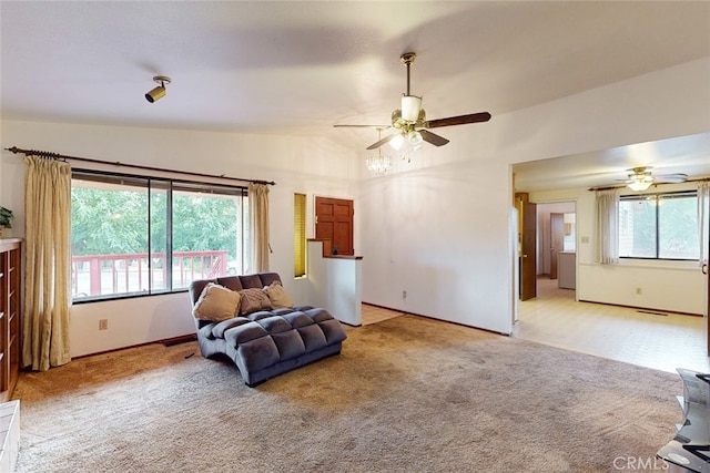 sitting room with light carpet, ceiling fan, plenty of natural light, and vaulted ceiling