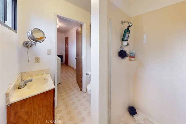 bathroom featuring vanity, toilet, and walk in shower