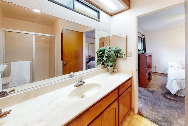 bathroom featuring vanity and an enclosed shower