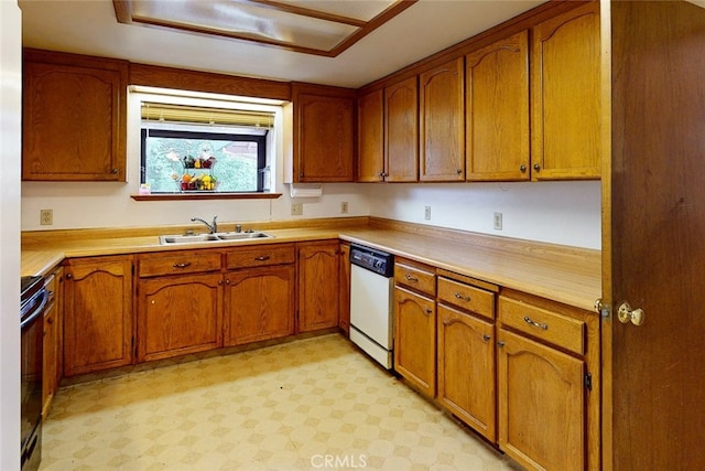 kitchen with dishwasher, sink, and black range oven