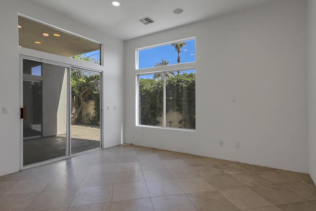 unfurnished room with light tile patterned flooring