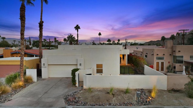 pueblo-style home featuring a garage