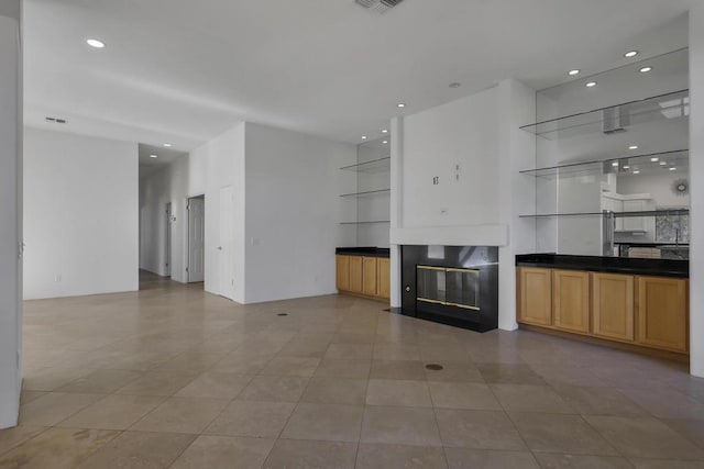 unfurnished living room featuring light tile patterned floors