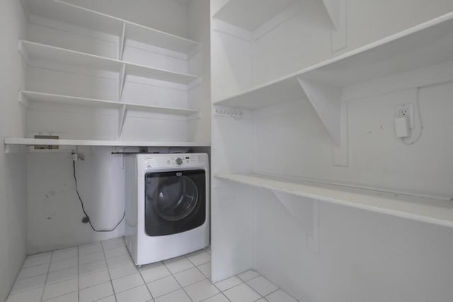 washroom with washer / clothes dryer and light tile patterned floors