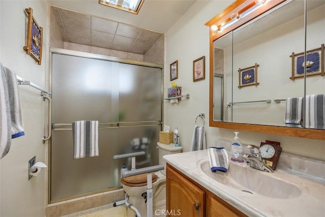 bathroom with vanity, an enclosed shower, and toilet