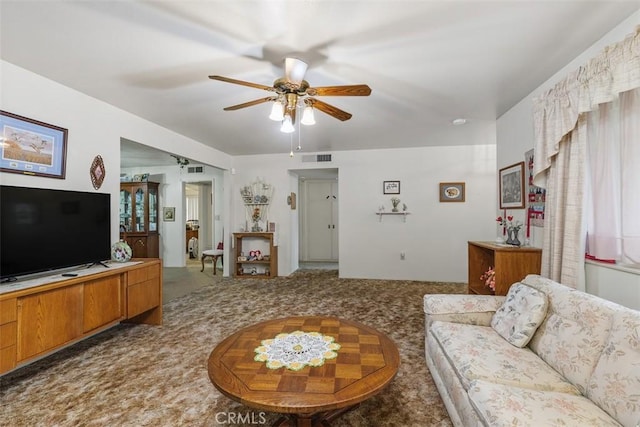 carpeted living room featuring ceiling fan