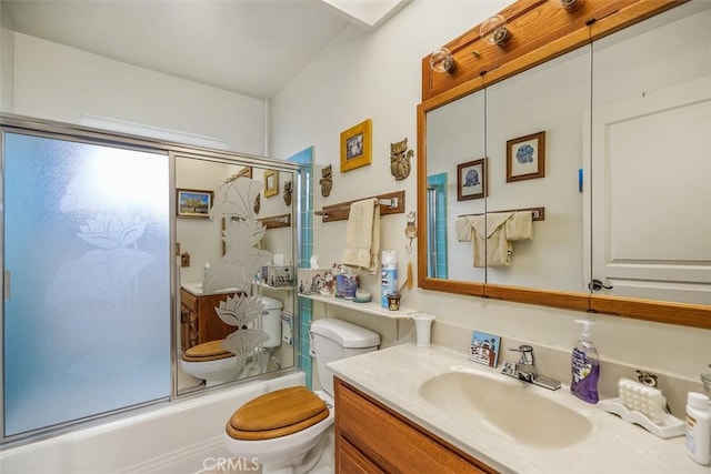 full bathroom featuring toilet, vanity, and combined bath / shower with glass door