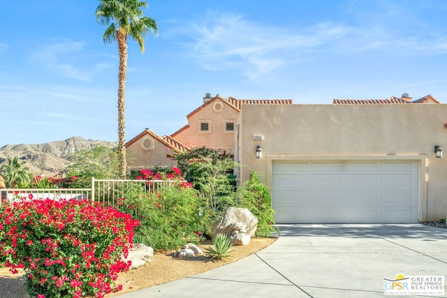 view of front of property featuring a mountain view and a garage