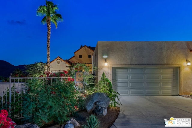 view of front of property featuring a garage and a mountain view