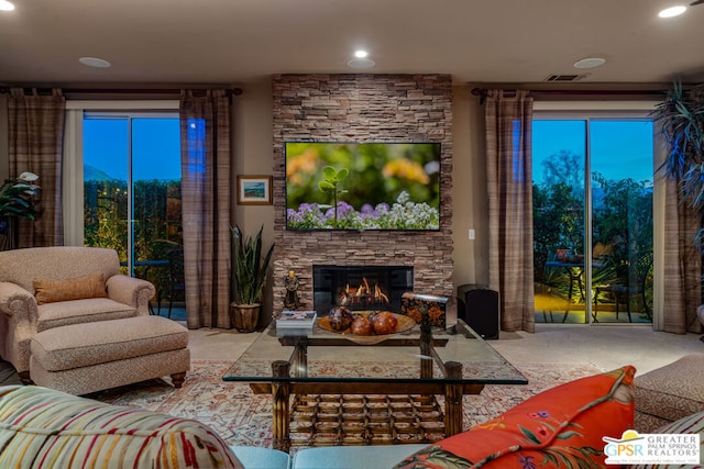 living room featuring a stone fireplace