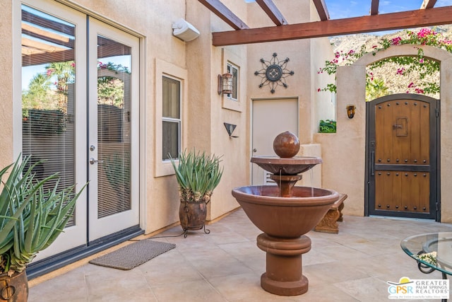 doorway to property with a patio, a pergola, and french doors