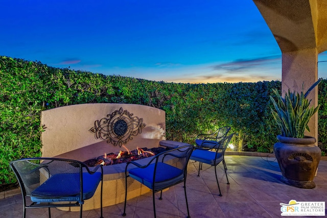 patio terrace at dusk with a fire pit