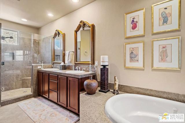 bathroom with a shower with door and vanity