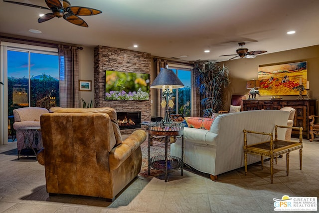 living room featuring a fireplace and ceiling fan