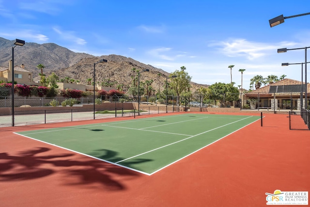 view of sport court featuring basketball hoop and a mountain view