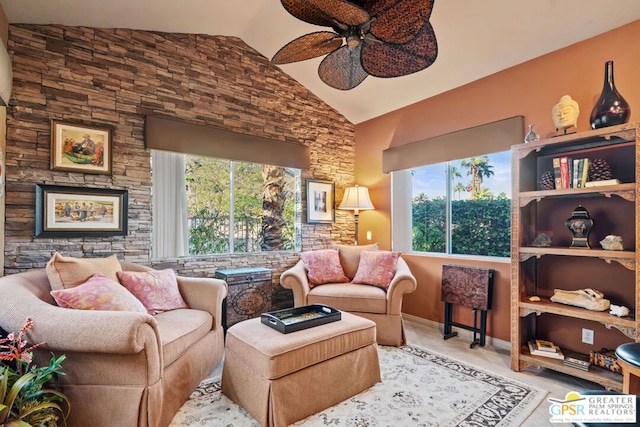 sitting room with vaulted ceiling, a healthy amount of sunlight, and ceiling fan