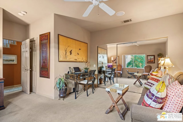 carpeted living room featuring ceiling fan