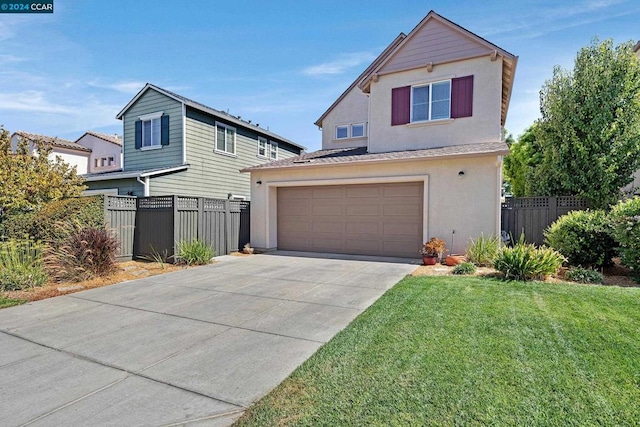 view of property featuring a front yard and a garage