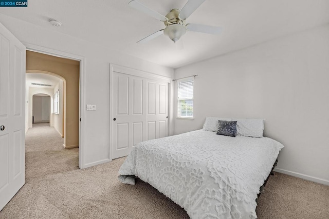 carpeted bedroom with a closet and ceiling fan