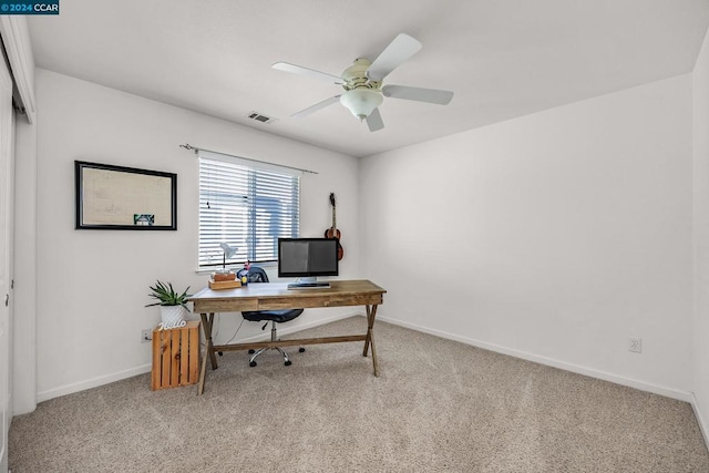 home office featuring light carpet and ceiling fan