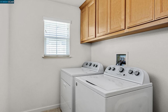 laundry room with tile patterned floors, cabinets, and separate washer and dryer