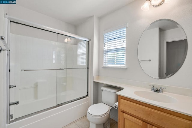 full bathroom with vanity, toilet, tile patterned floors, and combined bath / shower with glass door