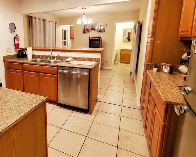 kitchen featuring pendant lighting, an inviting chandelier, sink, stainless steel dishwasher, and light tile patterned flooring