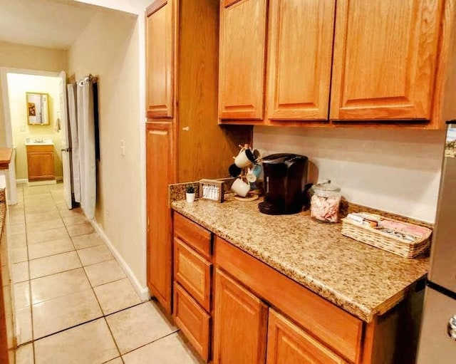 kitchen featuring light stone countertops and light tile patterned flooring