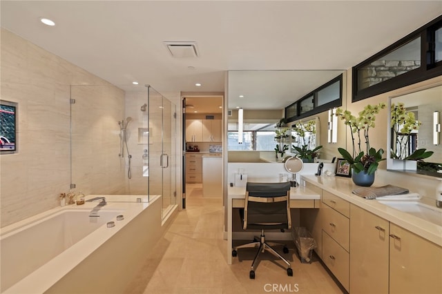 bathroom with vanity and separate shower and tub