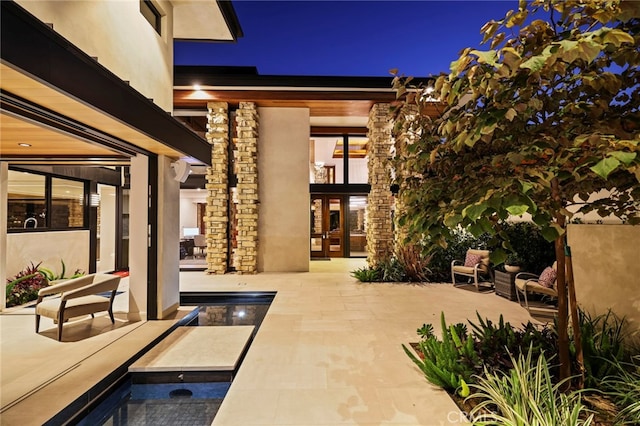 view of patio with french doors and a swimming pool