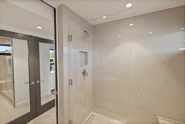 bathroom with french doors, walk in shower, and tile patterned flooring