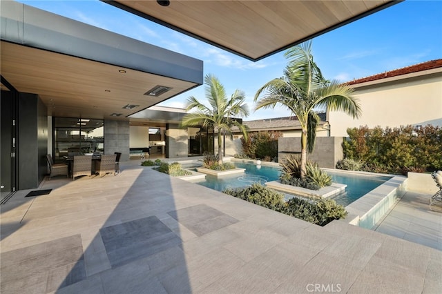 view of patio / terrace with a pool with hot tub