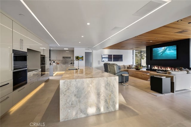 living room with sink and wood ceiling