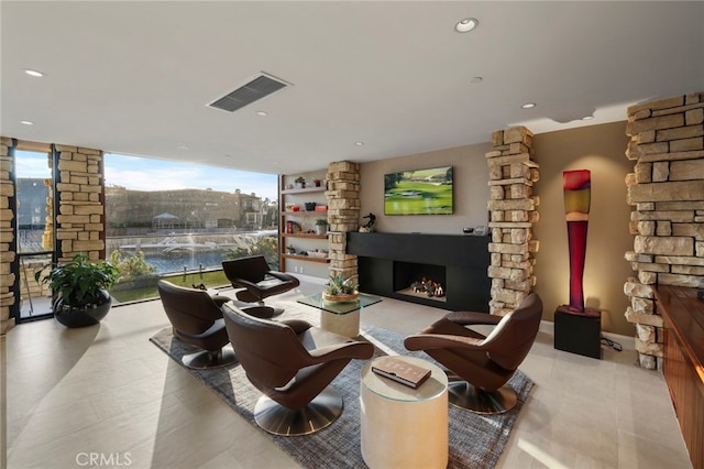 living room featuring plenty of natural light and floor to ceiling windows