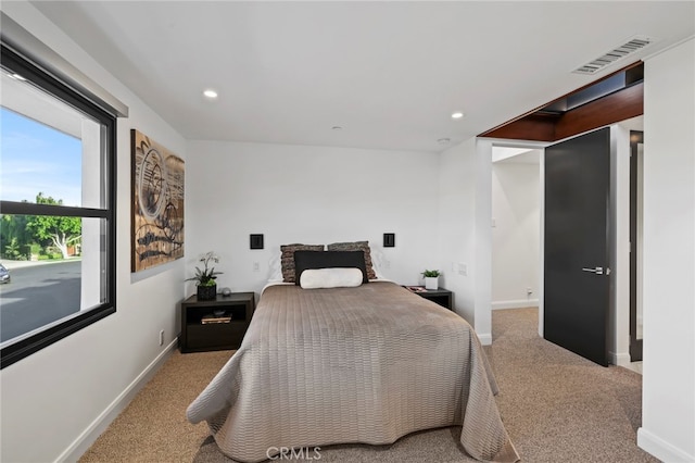 bedroom with light colored carpet