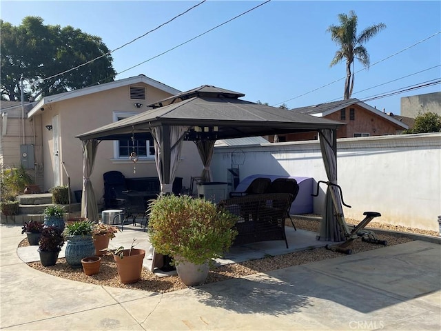 back of house featuring a gazebo and a patio area