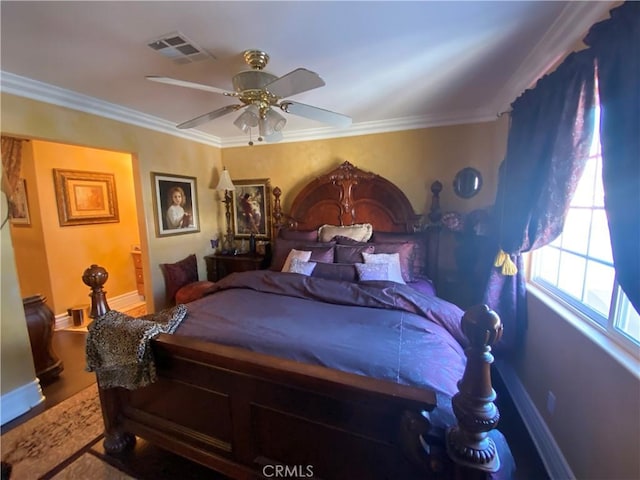 bedroom with ceiling fan and ornamental molding