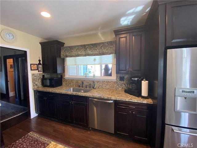 kitchen with sink, backsplash, dark hardwood / wood-style floors, and stainless steel appliances