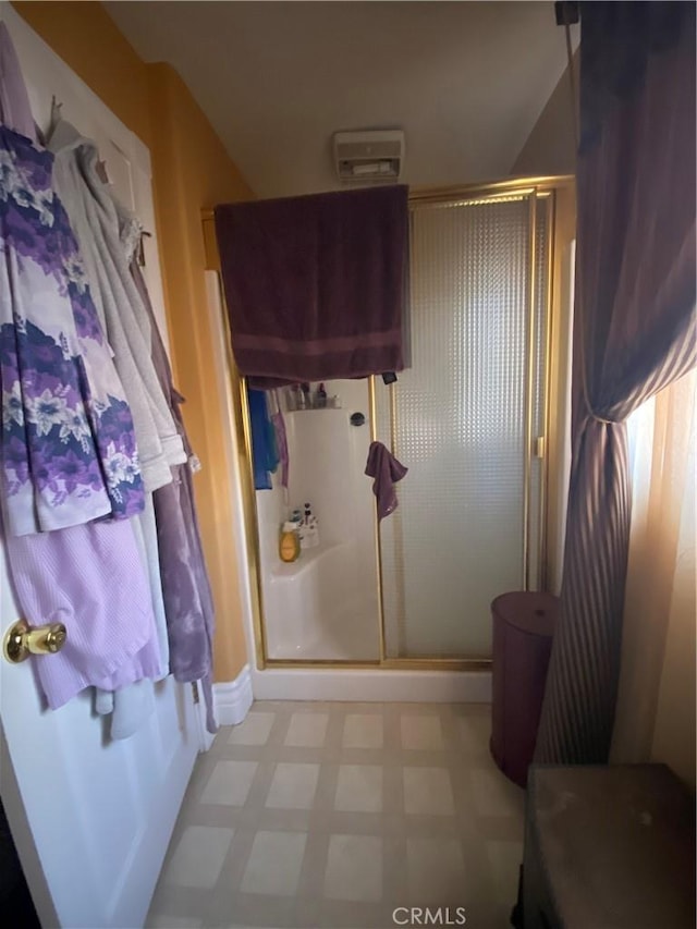 bathroom with a shower with shower door